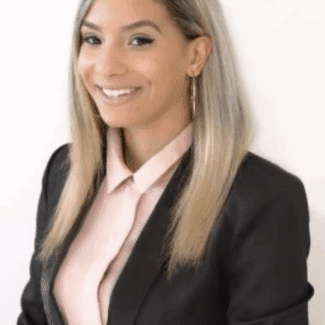 Jamee Joppy smiling at the camera against a white background.